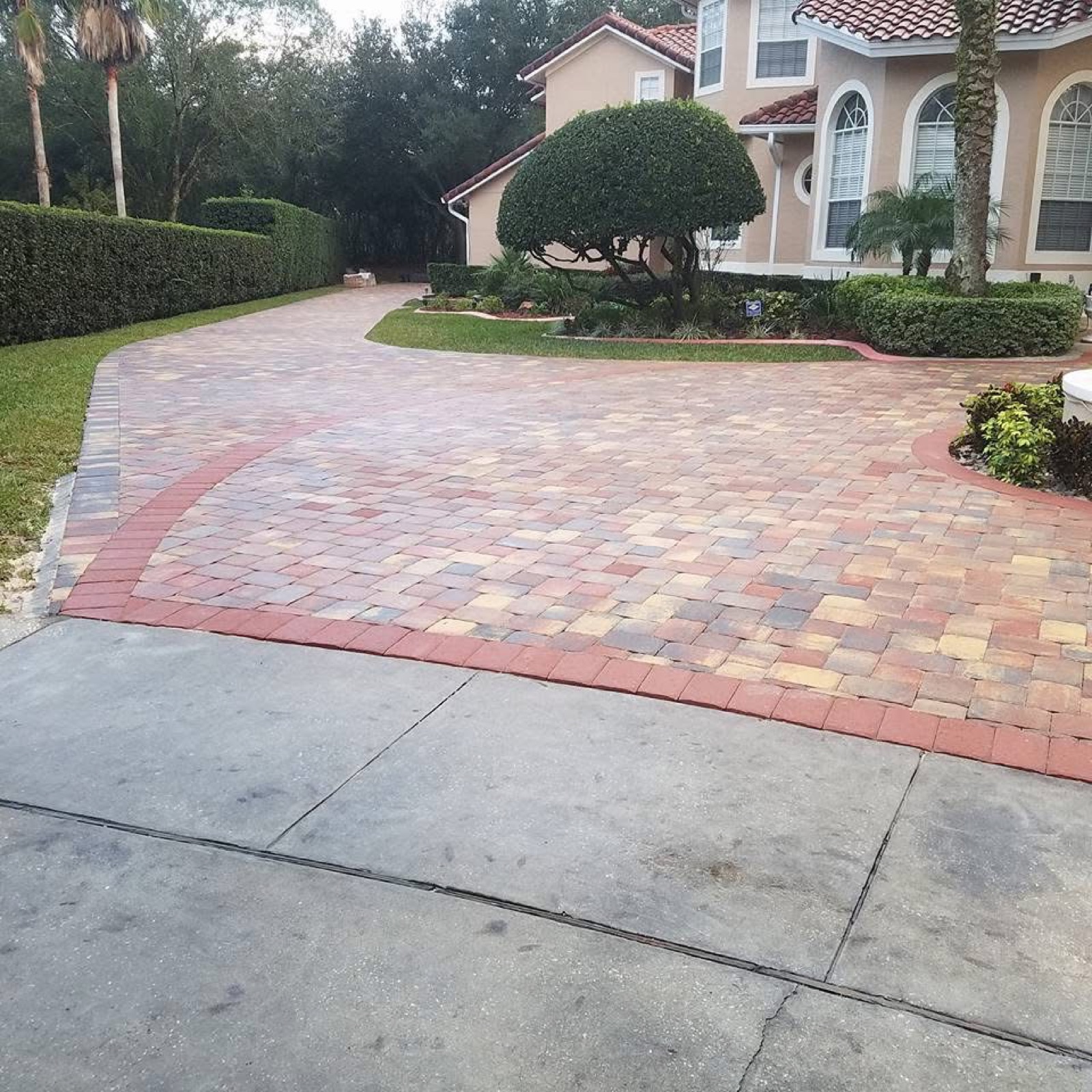 Multicolor paver driveway with red brick border