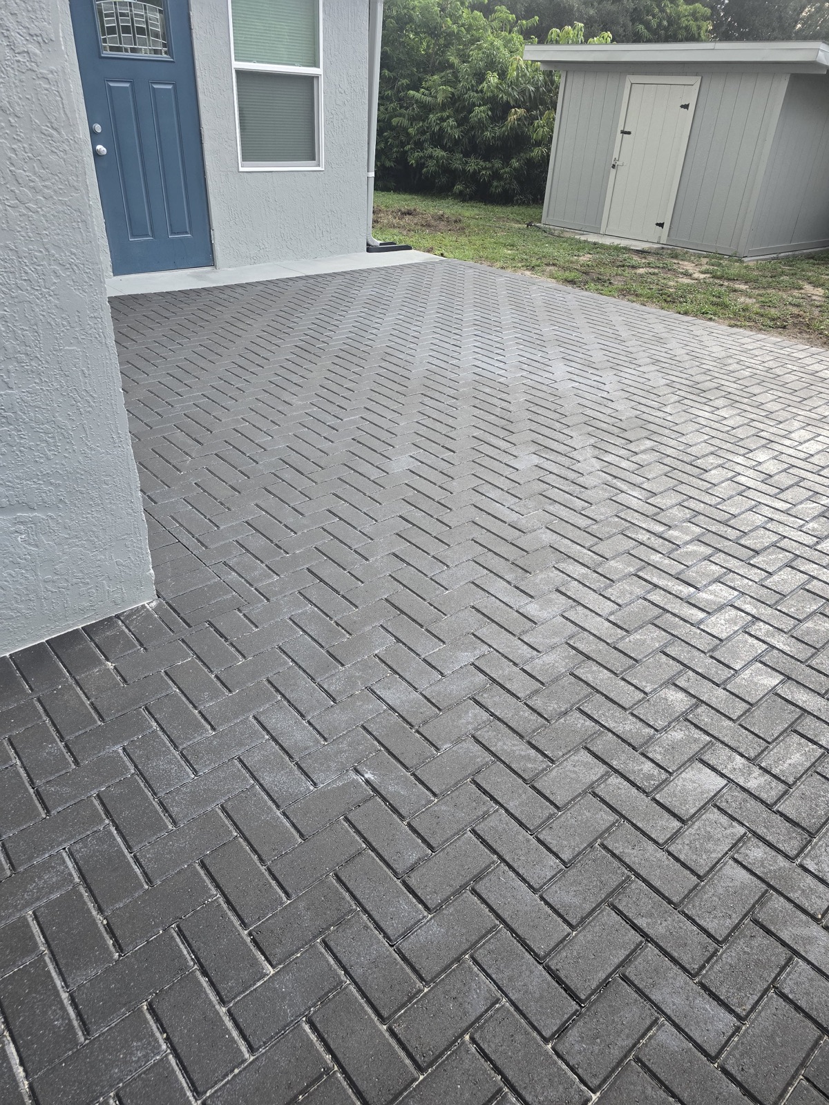 Herringbone paver patio at a home entryway