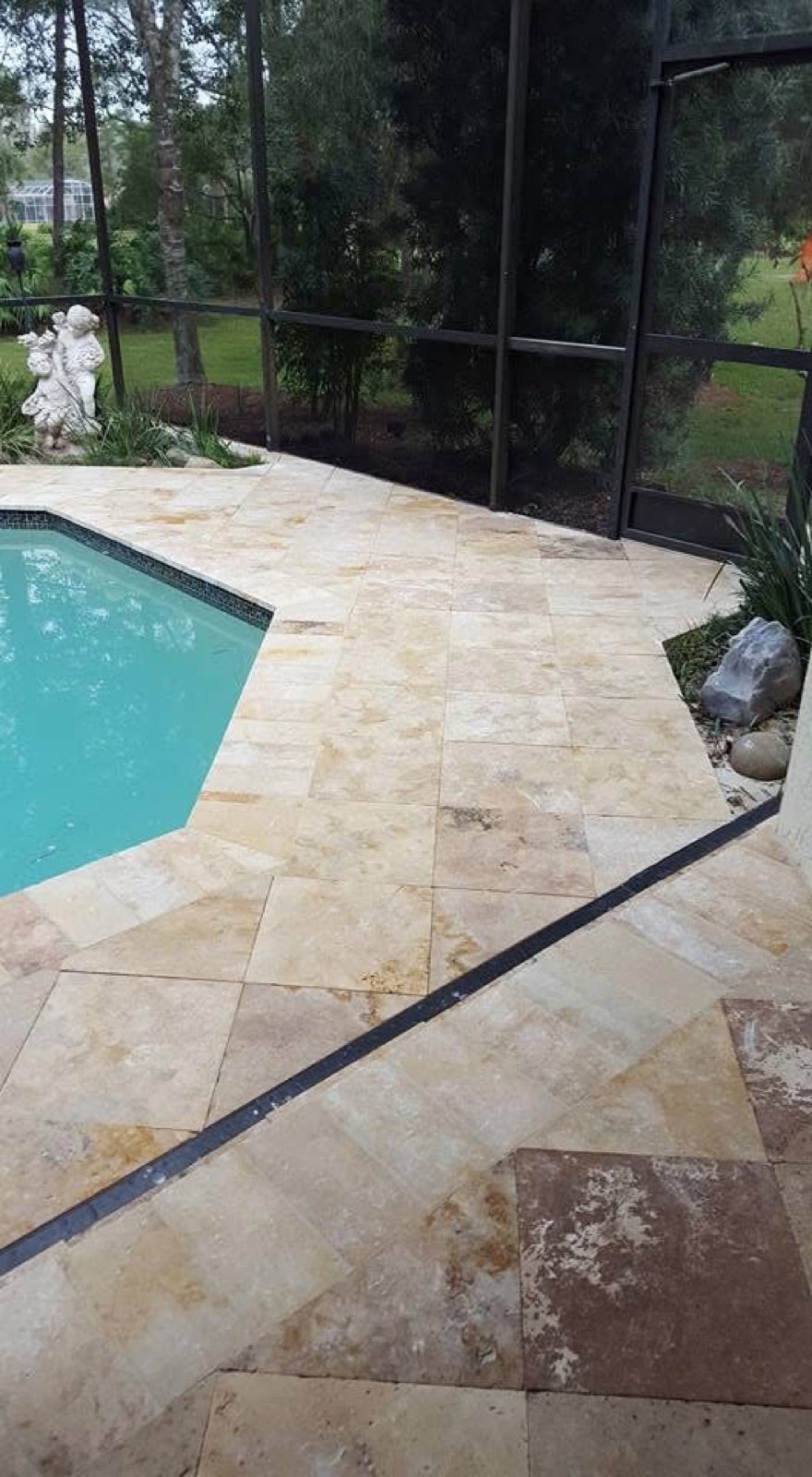 Travertine pool deck corner in a screened lanai